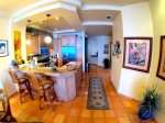 Open living, dining and kitchen areas.